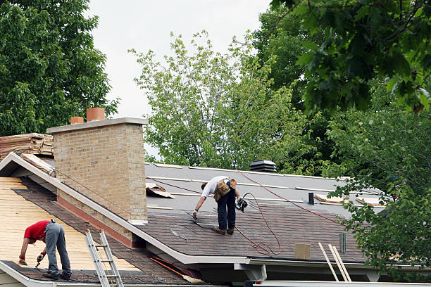 men installing a new roof on a house.